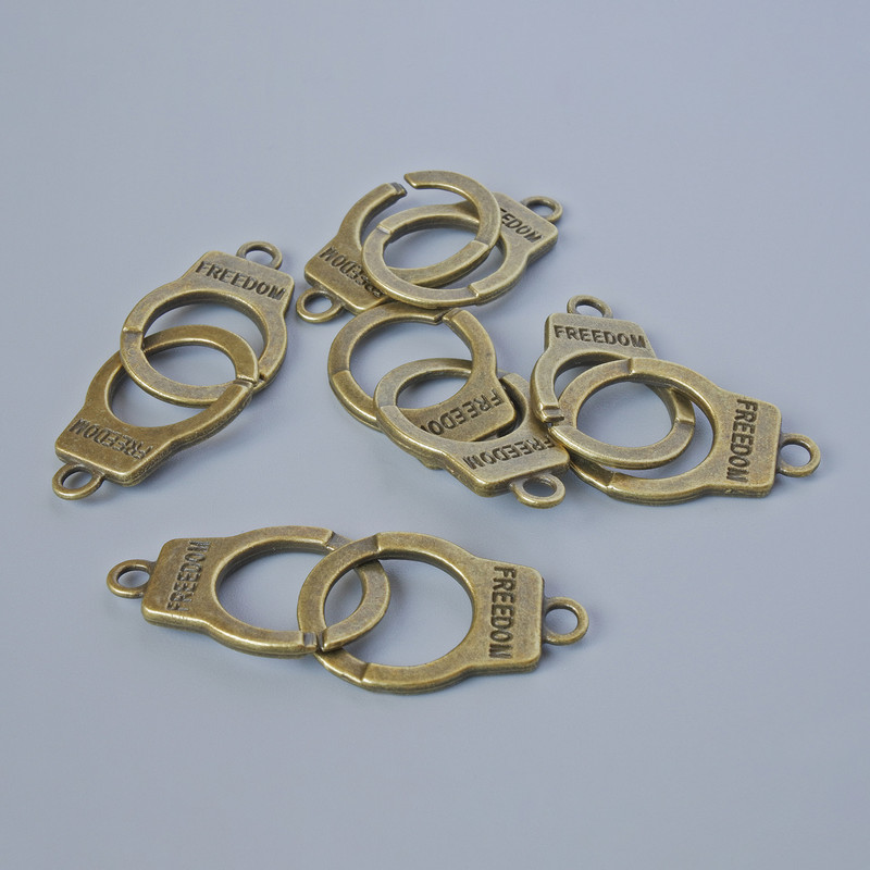 Furnitură pentru pandantiv «Cătușe», dimensiuni 23×14 mm, grosime 5 mm, diametrul găurii 2,4 mm, lungime 40 mm, pachet de 5 bucăți ±, culoare bronz a metalului