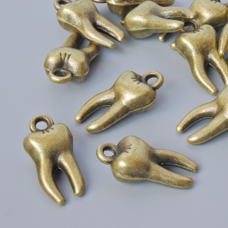 Furnitură pentru pandantiv «Dinte», diametru 15,5×7,5 mm, diametrul găurii 1,6 mm, ambalaj 15 buc +/-, culoare bronz metalic