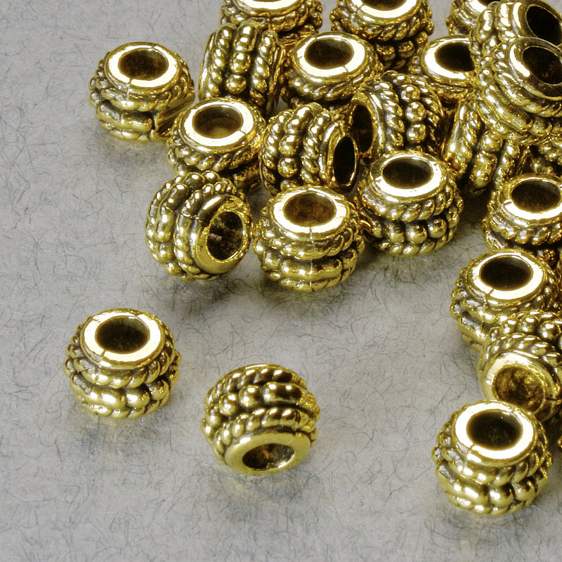 Furnitură – mărgea-inserație, diametru 5×6,5 mm, gaură de 2,8 mm, culoare aurie a metalului, ambalaj 20 g ± 38 buc.
