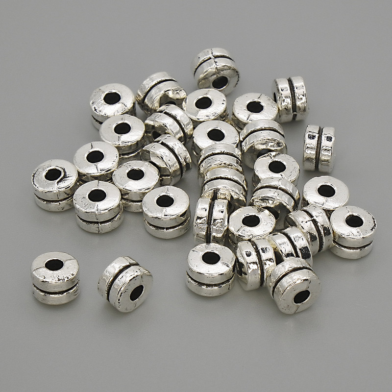 Furnituri pentru bijuterii: mărge-inserție argintie, diametru 6×4 mm, gaură 2,2 mm, ambalare 20 g (~30 buc.)