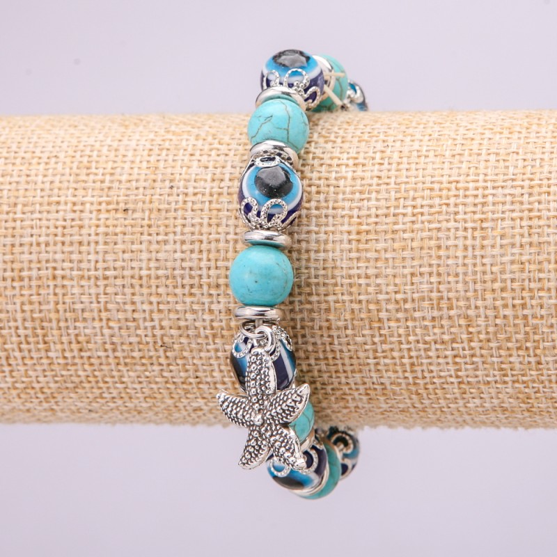Brățară de protecție din turcoaz cu ochi albaștri pe elastic, diametrul aproximativ 10 mm, lungimea 18 cm, cu inserții și pandantiv Stea de mare
