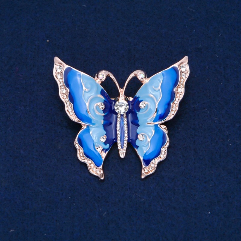 Broșă fluture, strasuri albe, email albastru deschis și albastru închis, metal auriu 47×52 mm +