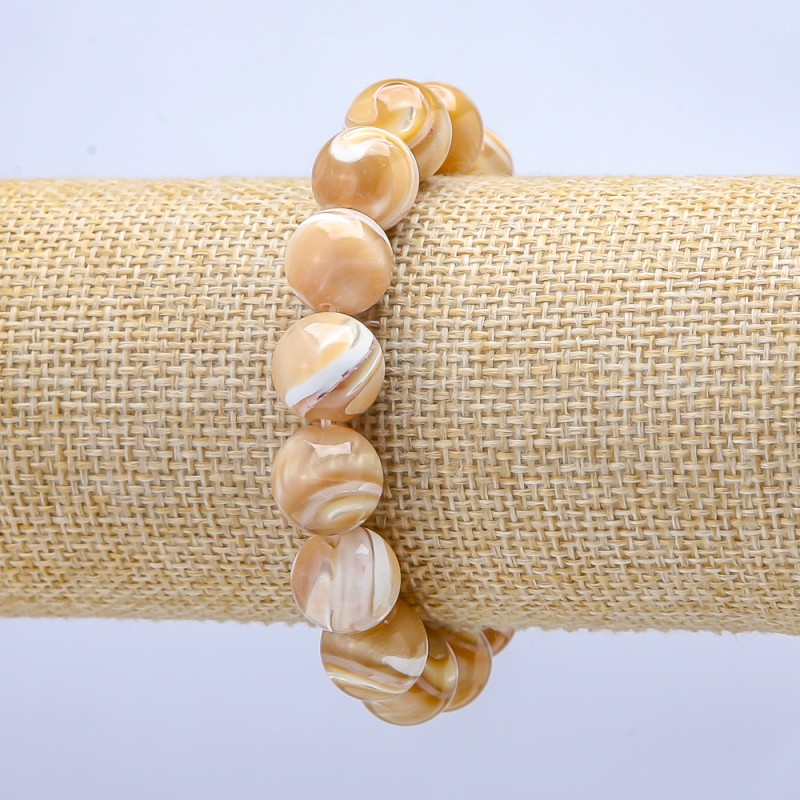Brățară pe elastic, sidef natural bej. Bilă netedă, diametru aproximativ 10 mm, lungime 18 cm.