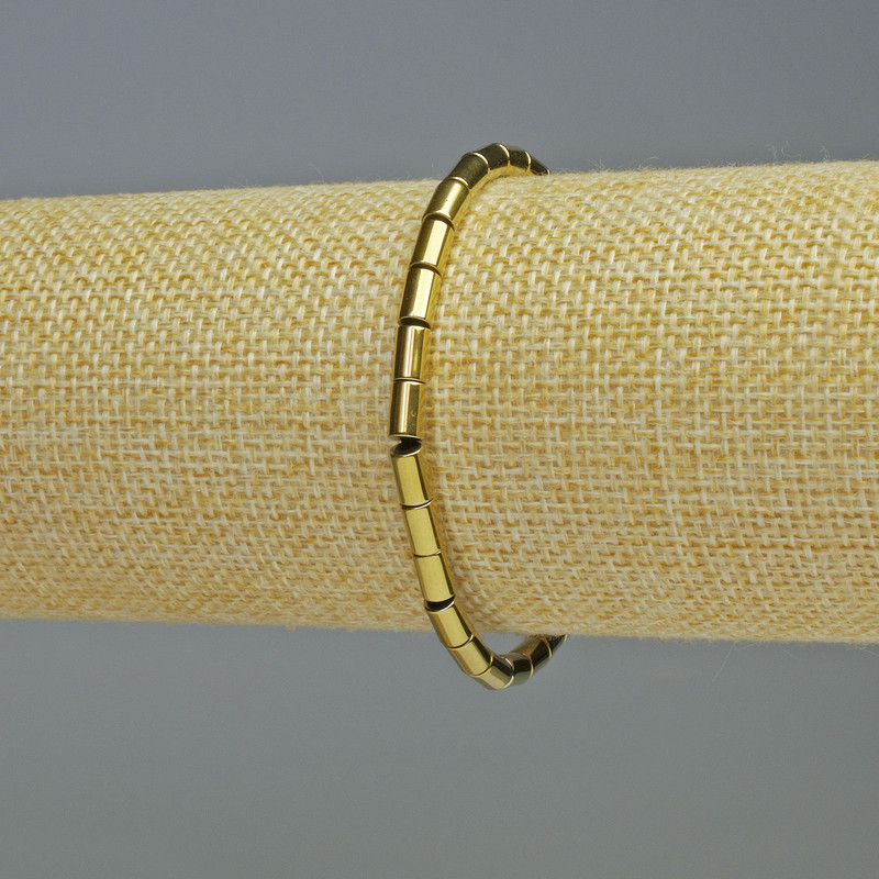 Brățară din hematit cilindric, culoare aurie, diametru 6×4 mm, lungime 18 cm, pe elastic