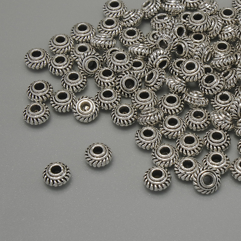Inserție mărgea argintie, culoare metal argintiu, diametrul 5×3 mm, gaură de aproximativ 1,7 mm, ambalaj 20 g (~99 buc.).